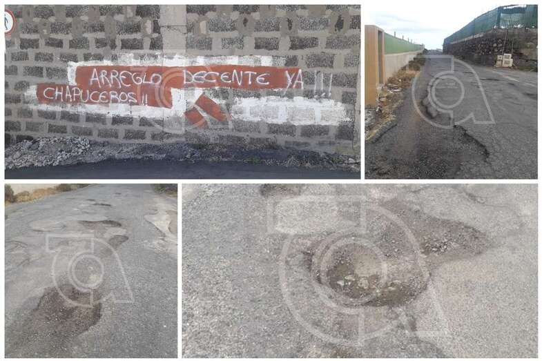 Pintada de los vecinos reclamando el arreglo decente del firme de la carretera (Foto TA)